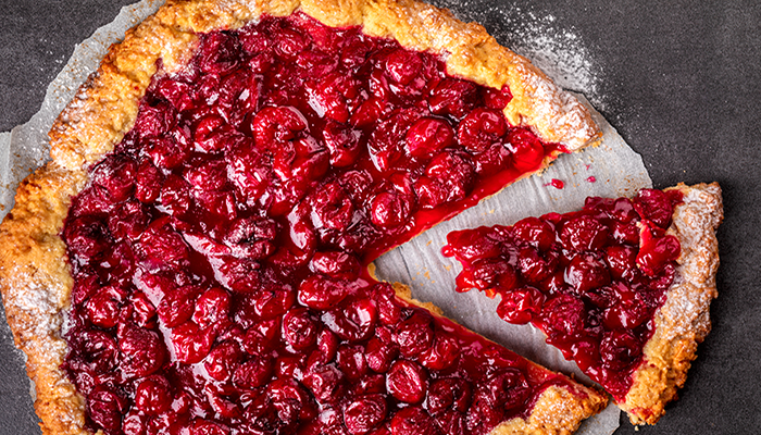 Fresh cherry tart with slice