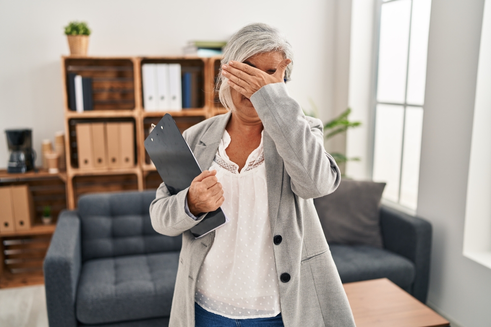Middle,Age,Woman,With,Grey,Hair,At,Consultation,Office,Covering