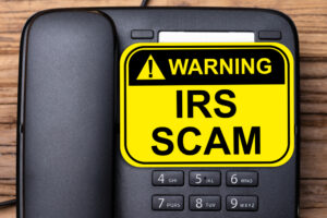 Elevated,View,Of,Irs,Scam,Warning,Sign,On,Black,Landline