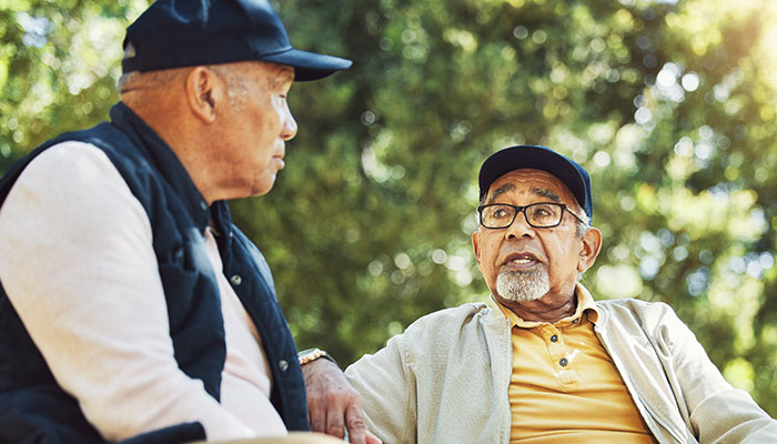 2SZMfriendsTalkingSincerelyInPark AdobeStock 653675744 700x400