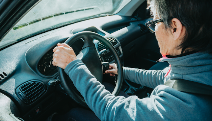 Older adult starting a car